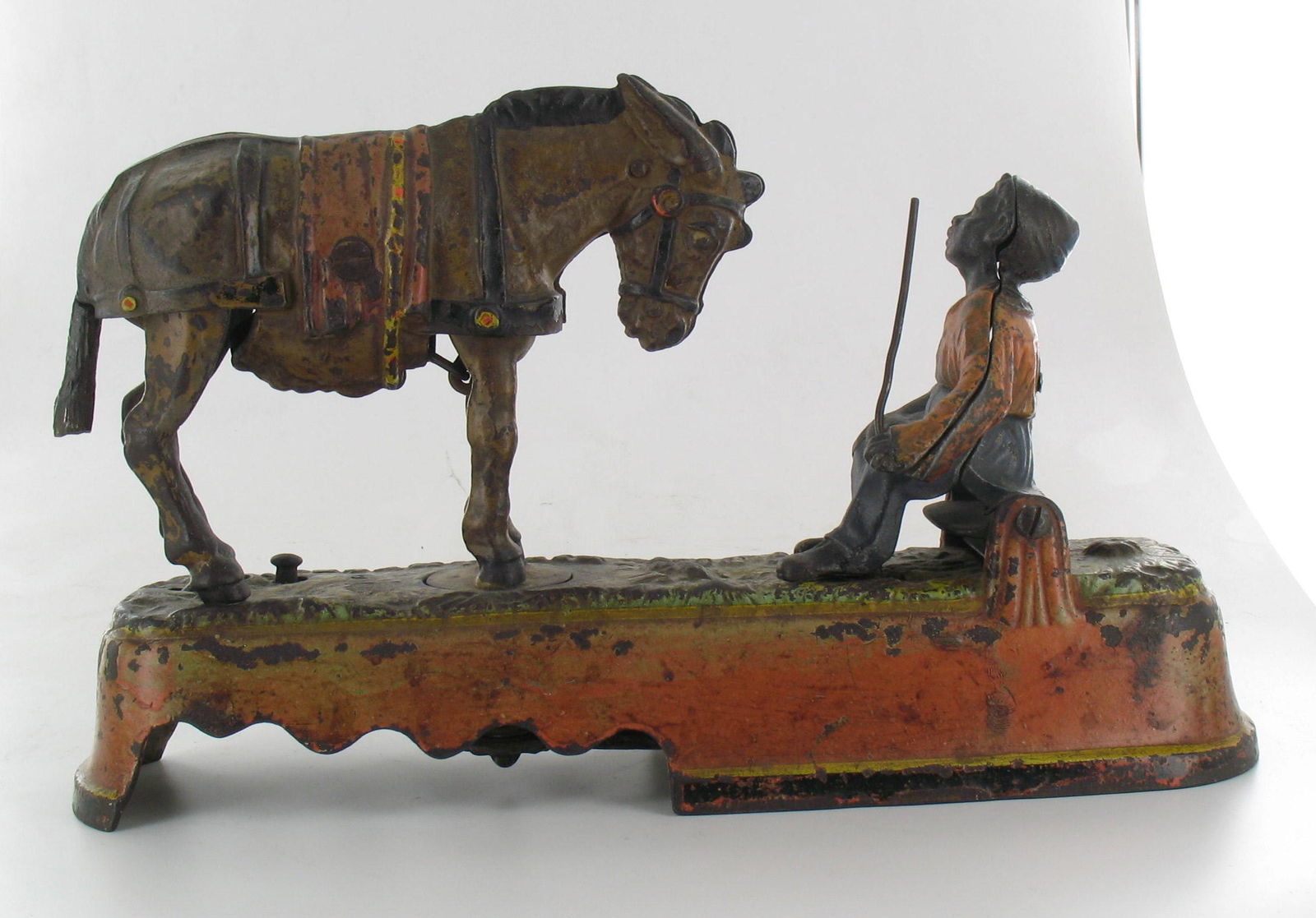 I Always did 'Spise a Mule Mechanical Bank: Made by J. & E. Stevens. Company Cromwell, Connecticut. Circa 1879. Cast Iron. Boy seated on bench with coin trap. Good Condition.