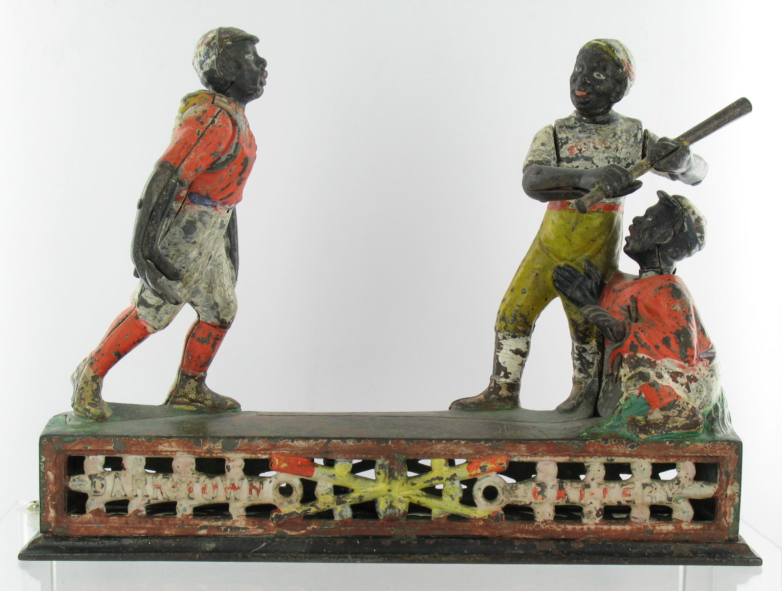Rare Darktown Battery White Uniforms Bank: Made by J. & E. Stevens. Cromwell, Connecticut. Circa 1880's. With Rare White Uniform. Mechanical Bank. Cast Iron. Batter in light shirt, pitcher in light trousers. With coin trap, minor damage to tra