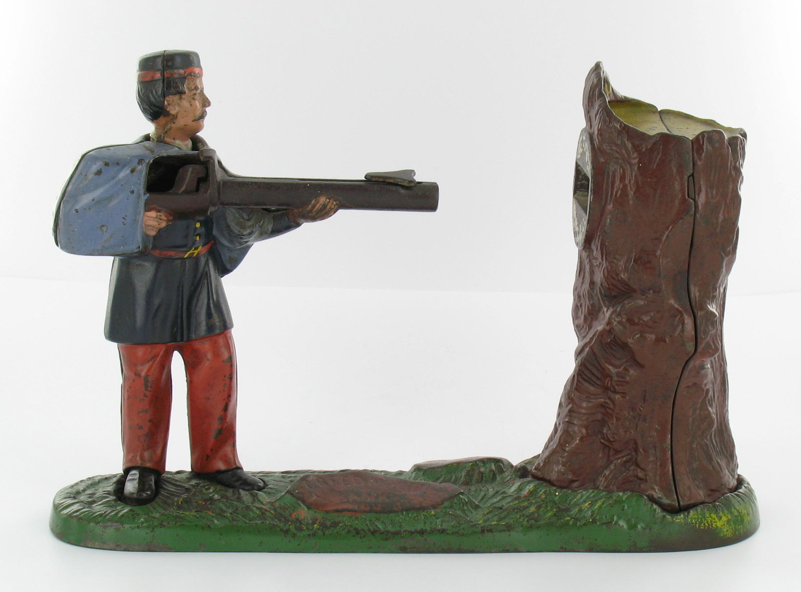 Creedmore Mechanical Bank: Made by J. & E. Stevens. Cromwell, Connecticut. Circa 1890. Cast Iron. Blue jacket and red trousers. With coin trap. Excellent Condition.