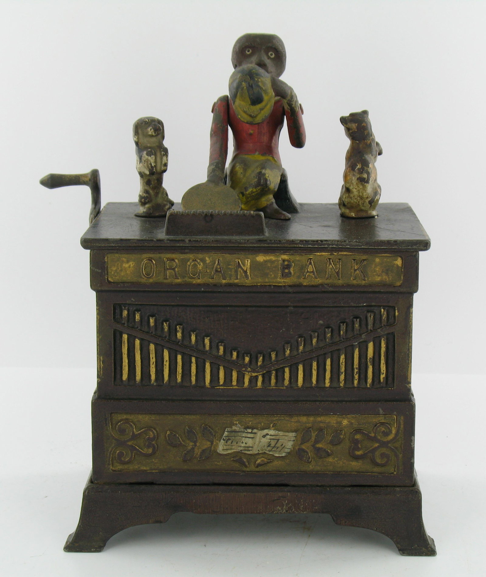 Organ Bank Cat and Dog Mechanical Bank: Made by the Kyser & Rex Company. Philadelphia, Pennsylvania. Circa 1882. Cast Iron. With locking trap and original key. Very Good Condition.