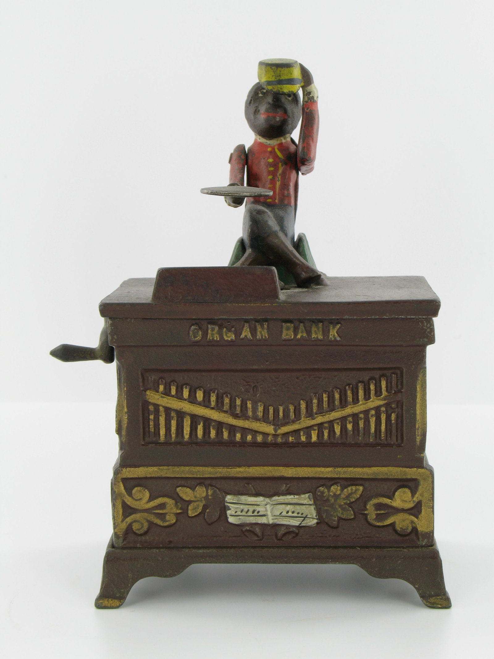 Organ Bank Medium Mechanical Bank: Made by the Kyser & Rex Company. Philadelphia, Pennsylvania. Circa 1882. Cast Iron. With locking trap and original key. Excellent Condition.