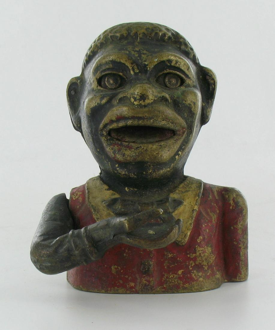 Jolly Man Brass Mechanical Bank: Unknown Maker. Cast Iron. Wording on the back very close to Harper, Butterfly Tie. Long body screw is missing. No base. Good Condition.