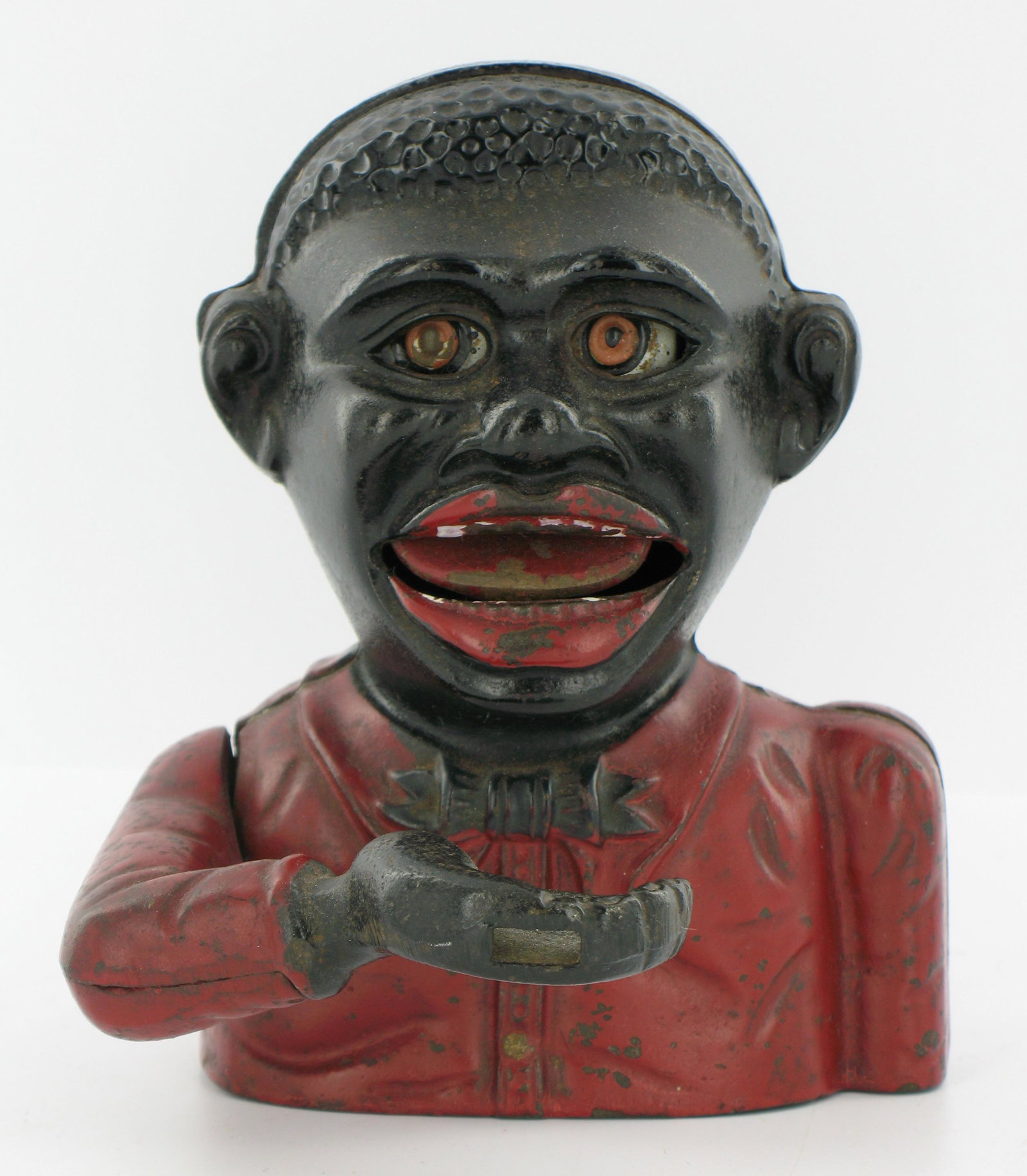 Little Joe Type 1 Mechanical Bank: Made by John Harper. England. Circa 1915. Cast Iron. Red coat and black tie. "Made in England" engraved on underside. Two part cast arm. Plate base. Excellent Condition.