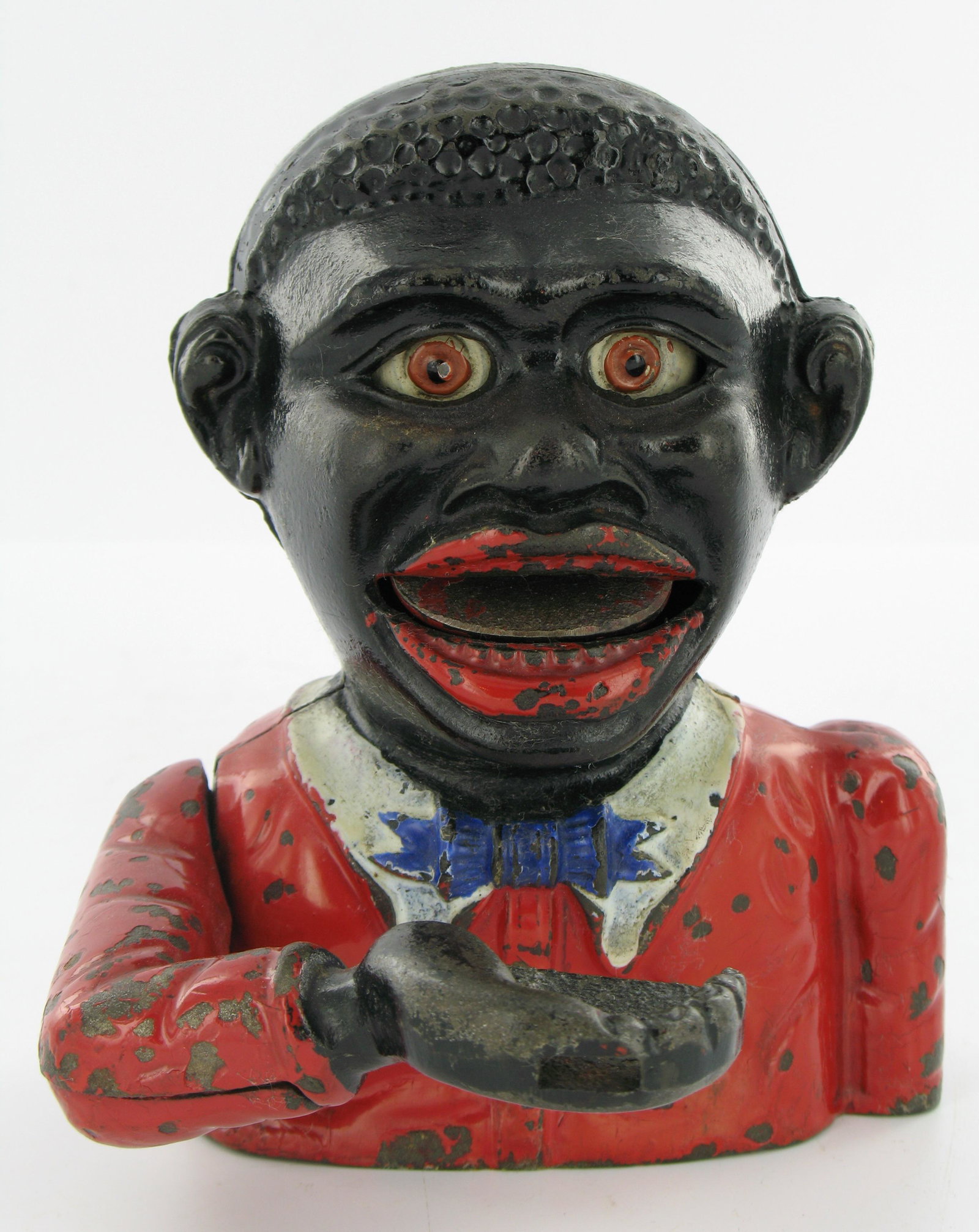 Little Joe Type 2 Mechanical Bank: Made by John Harper. England. Circa 1920. Cast Iron. Red coat, white collar and blue tie. "Made in England" engraved on inside back piece. Two part cast arm. Plate base. Excellent Condition.