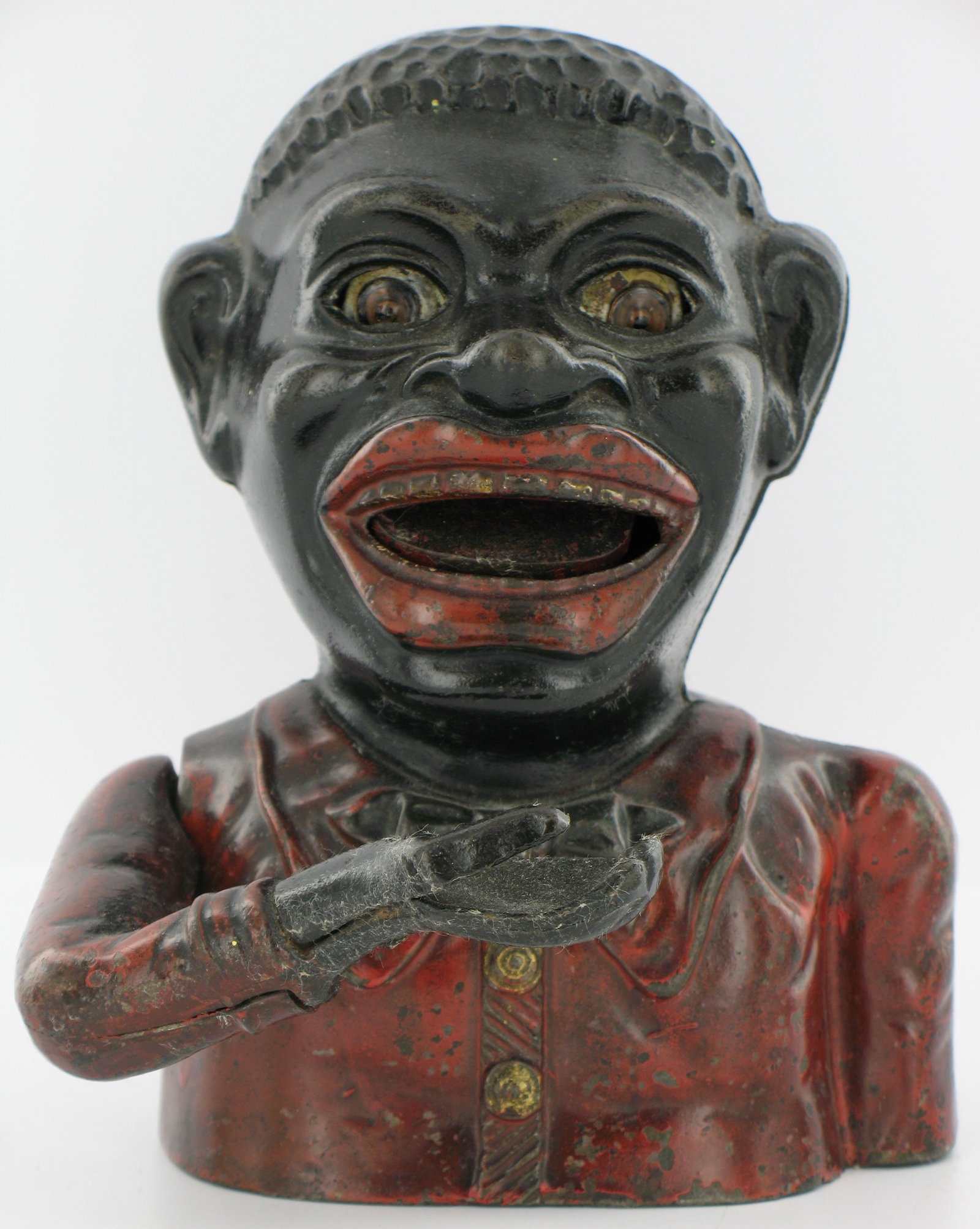 Jolly Man Harper Butterfly Tie Bank: Made by John Harper. England. Circa 1905. Cast Iron. With red tie, two part cast arm with steel thumb. Holed base. Very Good Condition.