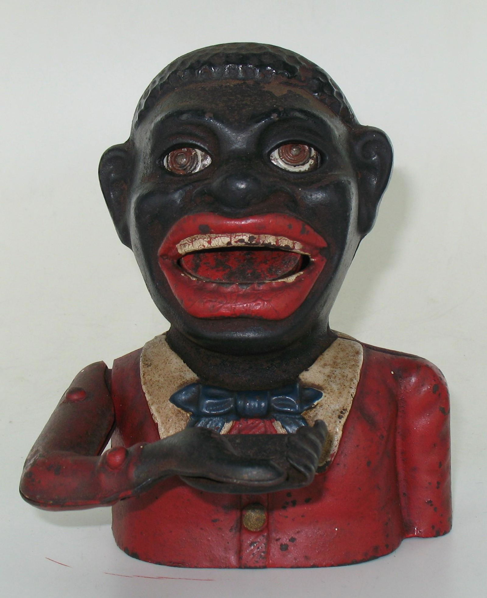 Jolly Man Harper Butterfly Type 2 Bank: Made by John Harper. England. Circa 1920. Cast Iron. With white collar, blue tie and two piece steel plate arm riveted together. Plate base. Excellent Condition.