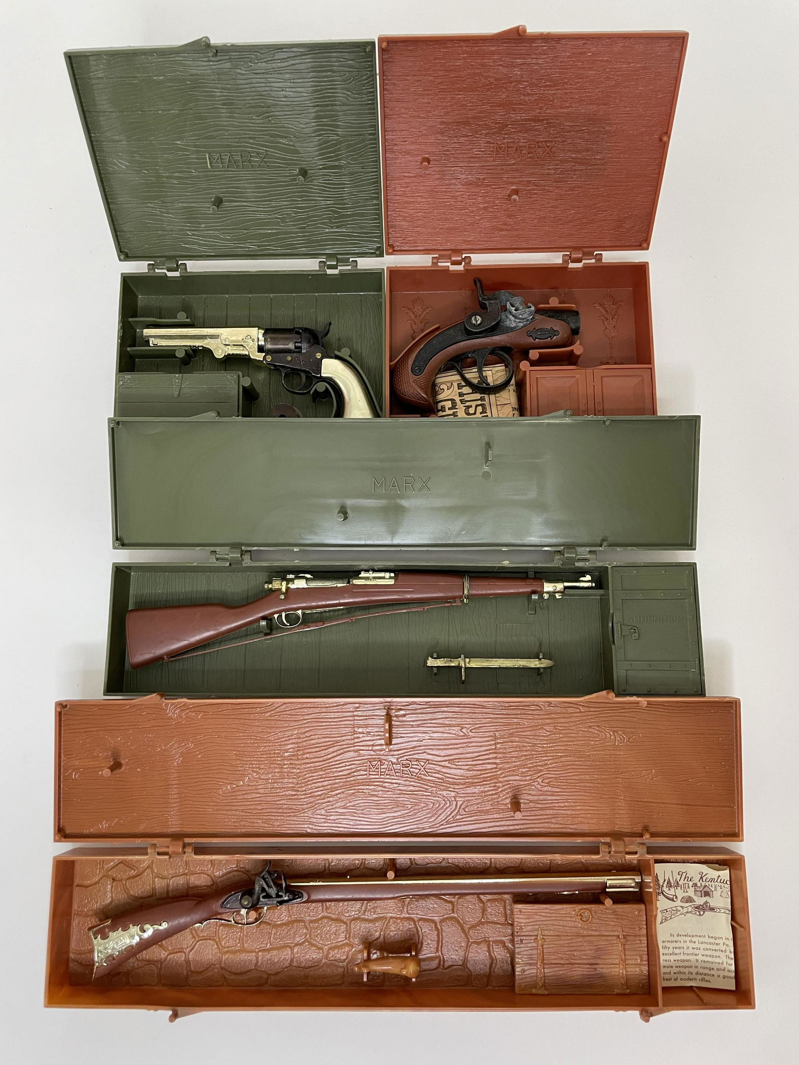 Lot Marx Miniature Toy Pistols and Guns: Including Stage Coach Pistol, The Darringer, The Springfield Rifle Model 1903 and the Kentucky Rifle. All in original plastic cases. 4 Pieces. Very Good Condition.