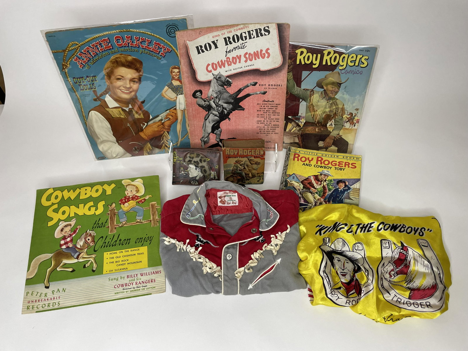 Lot of Roy Rogers Accessories: Including scarf, western shirt, The Better Little Book Roy Rodgers Crossed Feathers Ranch, Little Golden Book Roy Rogers and Cowboy Tony, Roy Rogers comics, Roy Rogers cowboy songs, 2 albums and a Dav