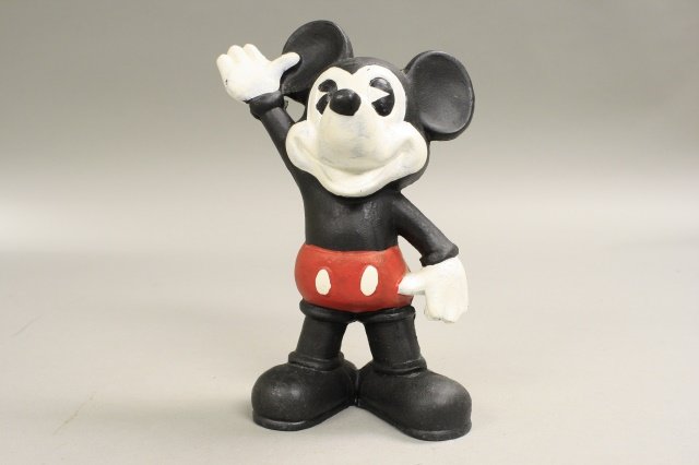Mickey Mouse: American 1970's. The bank is 9" tall and made of cast iron. The bank is in excellent condition.