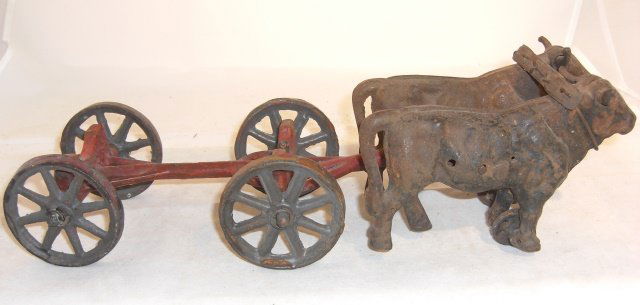 CAST IRON OXEN WITH CART: 2 pieces, 14 7/8" long, 4 1/2" high; condition fair