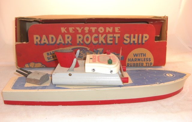 KEYSTONE "RADAR ROCKET SHIP" IN ORIGINAL BOX: Wood ship 14" long; box 14 1/2" long; two rocket firing tubes, no rockets; turret swivels; ship condition very good, box fair