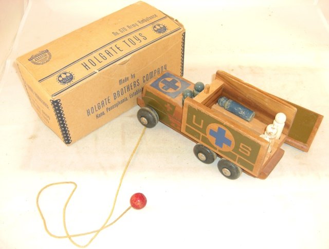 HOLGATE "670" ARMY AMBULANCE: Wood; 8 3/4" long; original box 9 1/4" long; 7 "people"; condition very good in good box