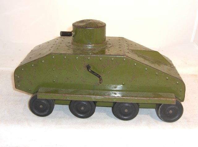 STRUCTO METAL TANK: 9" long, 6 1/2" wide; 1935; wood wheels; turret turns; makes gun firing noise when lever turned; condition good
