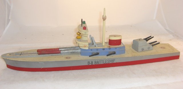 KEYSTONE B8 BATTLESHIP: Wood; 20" long; with 2 rockets; 1 spring firing mechanism works, 1 spring does not catch; condition good