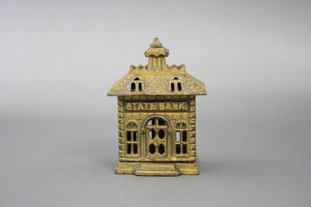 State Bank: State Bank (4 1/8" H). Made of cast iron and in very fine condition. Made by Arcade Mfg Co of the United States circa 1900.