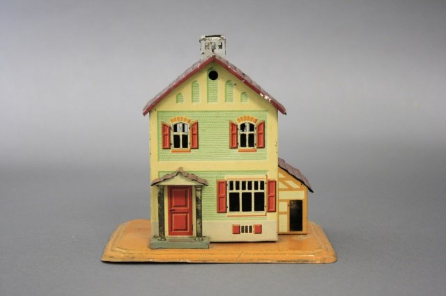 Tin House with Side Shed Bank: House with Side Shed (5 1/8" H). Made of tin and in excellent condition. Made by Bing of Germany circa 1930.