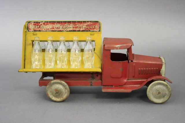Coca Cola Truck: Metalcraft Mfg. Co. American - Circa 1930. Made of Tin/glass bottles and 11" L. This is a wonderful image of a bygone era. All the bottles are original to the toy. Fine Condition (tires with some rust