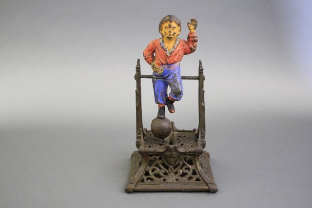 Boy on Trapeze Bank: Made by J. Barton Smith of America circa 1880. Made of Cast Iron. Fine Condition (back of figure fair condition).