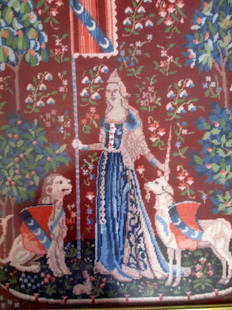 The Lady and the Unicorn - Touch: The Lady and the Unicorn - Touch The lady stands with one hand touching the unicorn's horn, and the other holding up the pennant. The lion sits to the side and looks on. Framed in gold decorated