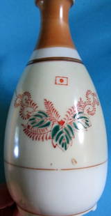 Japanese Signed Sake Bottle: Nice design on both sides.Hand Painted. Signed on base. Maker: Unknown Origin: Japan Date/Period: 20th Century Type: Saki Bottle Material: Porcelain Condition Report Excellent