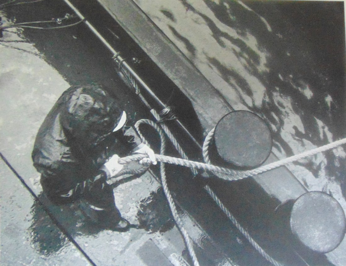 First Mate On A Harbor Tug Fastens the Bow: First Mate On A Harbor Tug Fastens the Bow Plate 45 Photographer: Wendy Holmes Dated: 1970's Subject: Hudson River Valley Medium: Halftone