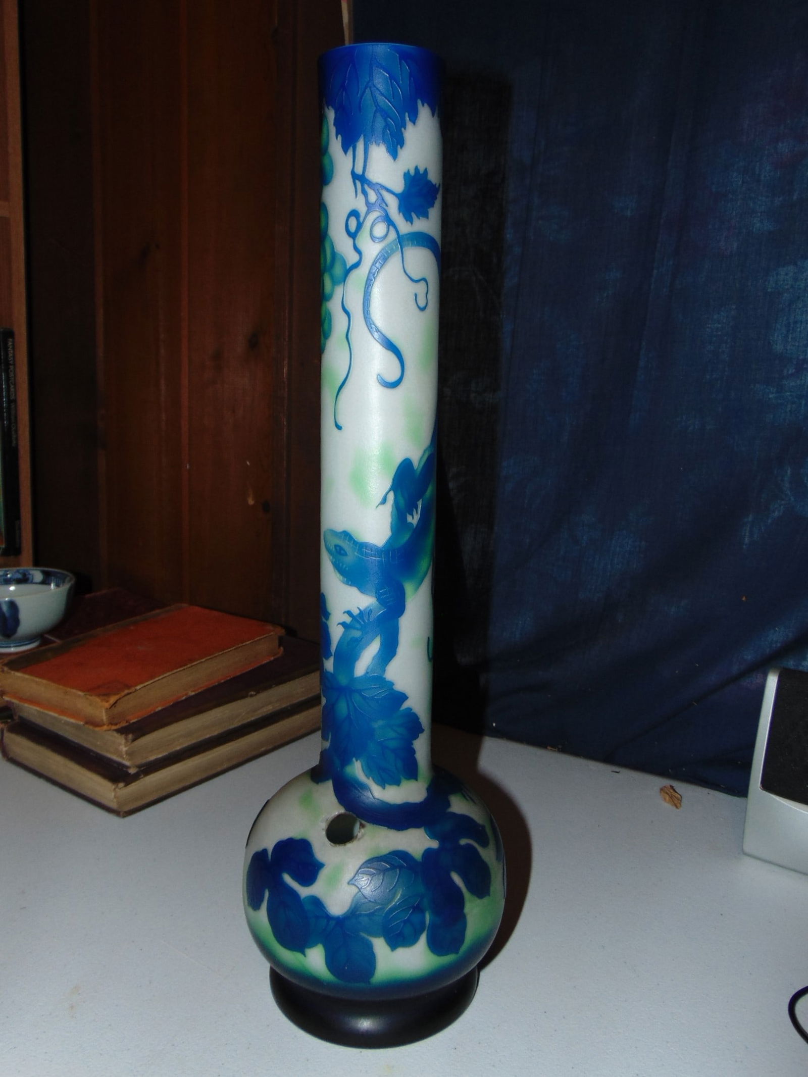Cameo Glass Vase: Cameo Blue Green Glass Vase Dimensions: 5 X 17.5" Condition Report Circular hole on side. No other defects noted. See photo
