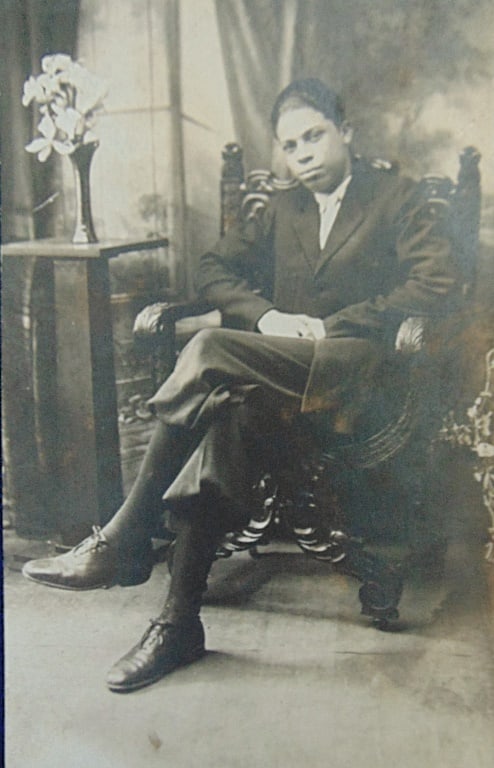 Early Photograph of Black Gentleman RPPC: Early Photograph of Black Gentleman Seated - RPPC Undivided back. Dated: Circa 1900 Condition Report Slight clear tear top right edge. Good Plus Subject References: PCB2