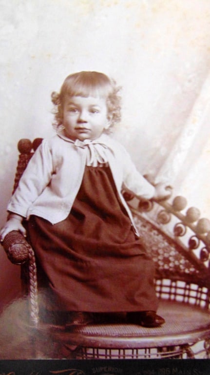 Young Girl In Wonderful Wicker Chair- C. H. Gallup: Young Girl In Wonderful Wicker Chair- With Gold over Black image of his building as back stamp. Photographer: Charles H. Gallup Dated: 1890's Subject: Portraits - Children Medium: Cabinet Card -