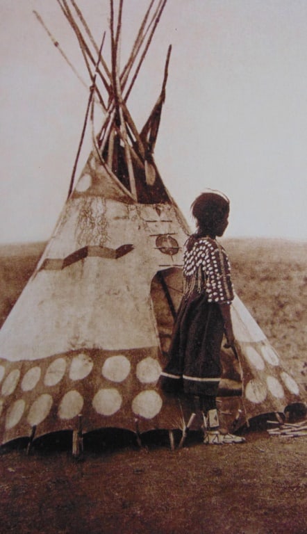 Piegan Child and Her Tepee: Piegan Child and Her Tepee From the National Geographic Image Collection. 2012 Photographer: Edward S. Curtis Dated: 1926 Subject: American Indians Medium: Halftone<