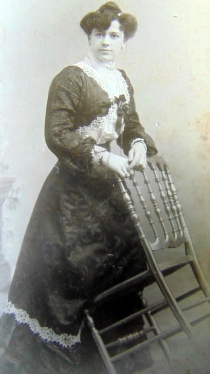 Atelier Bluhm - Lady with Tilted Chair: Atelier Bluhm - Lady with Tilted Chair Atelier Bluhm photographs are rare. This lady holds a tilled chair in a beautiful flowing gown. Photographer: Atelier Bluhm