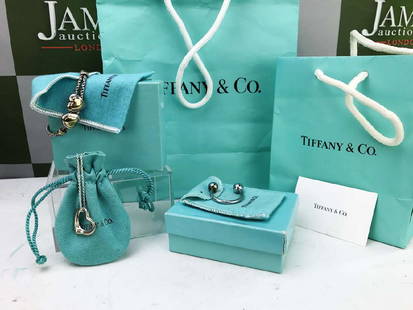 Tiffany & Co, Collection of Three lots: Tiffany & Co Collection of Three lots. Comprising of a pair of silver & gold hearts bracelet. Sterling silver heart necklace. Silver Key ring. All lots come with originalboxes ,pouches etc &