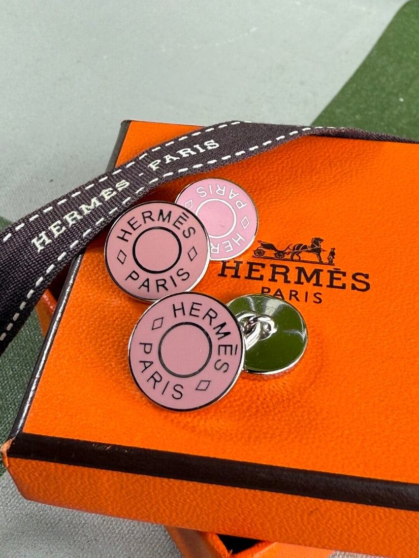 Hermes Paris-Rare `Clou De Selle` Pink Monogram Enamel Cufflinks: Hermes Paris-Rare `Clou De Selle`Pink Enamel Cufflinks- as pictured with original packaging including velvet Hermes pouch and outer Hermes Box. Excellent preowned examples.
