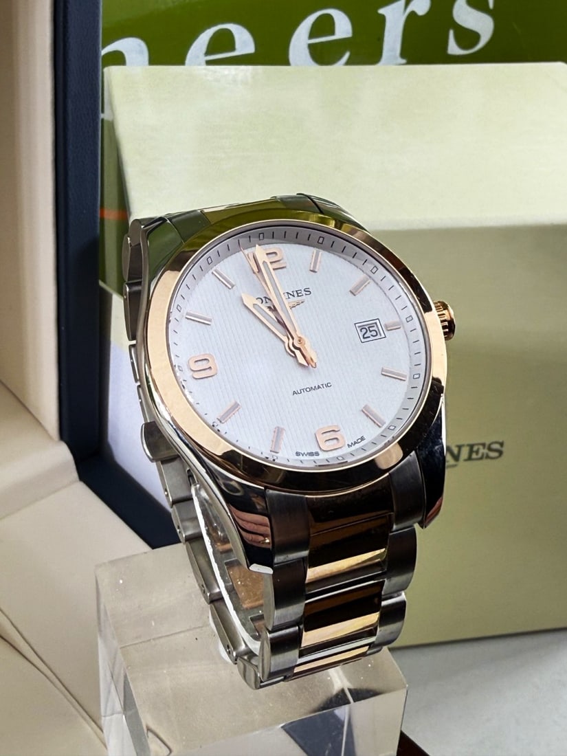 Longines Automatic Conquest Gold 40mm Edition: Longines - Conquest Stainless steel case with gold plated bezel. Signed automatic calibre L619.2. Silvered dial with baton hour markers, quarterly Arabic numeral hour markers, date aperture to three.