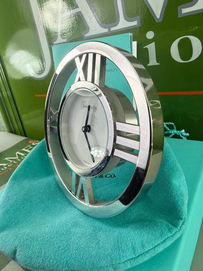 Tiffany & Co Large Atlas Edition Silver Tone Clock: Tiffany & Co Large Atlas Edition Clock, understood to of been instorage for over ten years, complete with as pictured original pouch and exterior packaging and manual etc.
