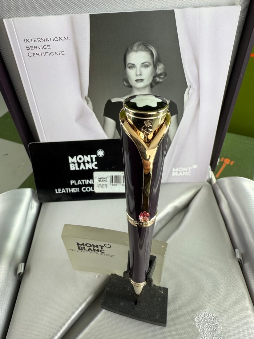 Montblanc Collection Princesse Grace de Monaco Rollerball Pen: Montblanc Collection Princesse Grace de Monaco Pen, mint example, understood to of been instorage for many years. Royal Purple Precious Resin: Features champagne-tone gold-plated fittings and a