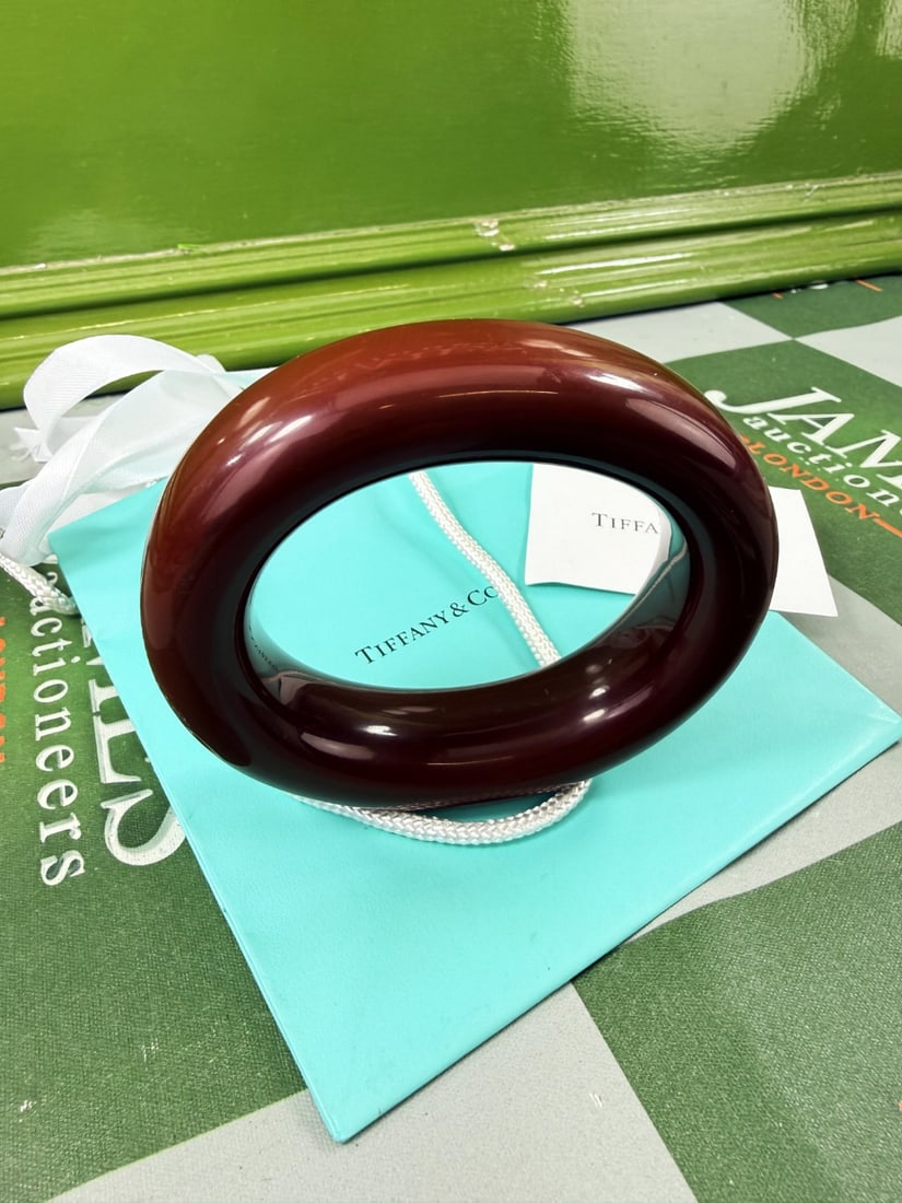 Tiffany & Co. Genuine Elsa Peretti Hardwood Lacquer Bangle: Tiffany & Co. Elsa Peretti Red Lacquer Bangle is handcrafted from Japanese hardwood and finished with a smooth, gleaming red lacquer, as pictured with various T & Co Packaging. Dimensions pict