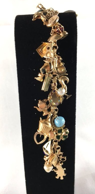 14k Gold Charm Bracelet w/ 29 14K Gold charms 74 GRAMS!: Gorgeous ladies 14k gold charm bracelet with 29 14k gold charms. Each charm is different, some are inset with rubies, some with emeralds, some with pearls. It's just delightful. Any lady would look ch