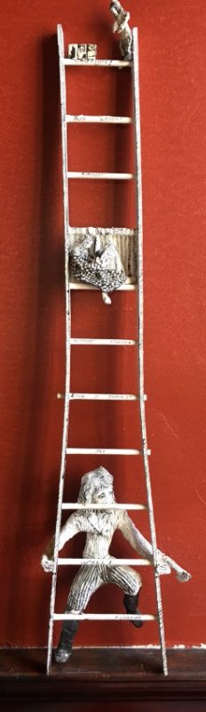 Outsider art sculpture by Shapiro Tim Burton-esque: Here is an interesting sculpture signed Shapiro. It is wood and paper mache' and is a ladder with a man climbing up to a woman sitting on a rung reading The Whole Earth catalog. It has a really odd Ti