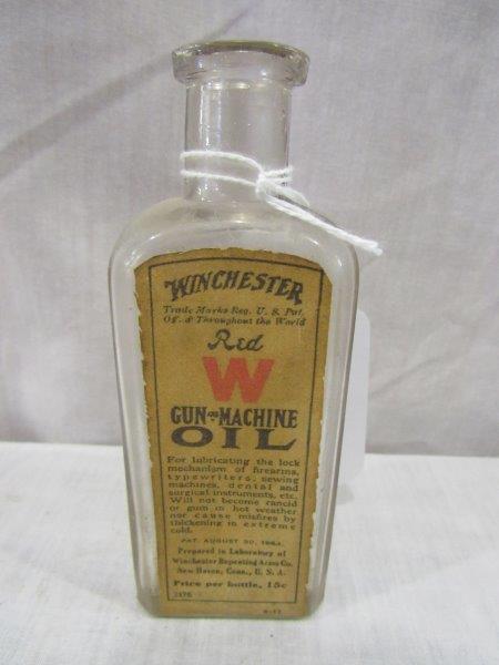 Winchester Red label gun and machine oil glass bottle: Original label and pretty nice condition bottle is also embossed.
