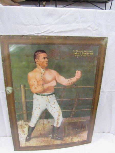 SST John L Sullivan Hohenadel Beer sign: Has some rust and pitting throughout sign also has what appears to be a bullet hole and another small hole in field. Is by Coshocton artworks and has a cardboard backer. 17 in x-23 in. Also has water 