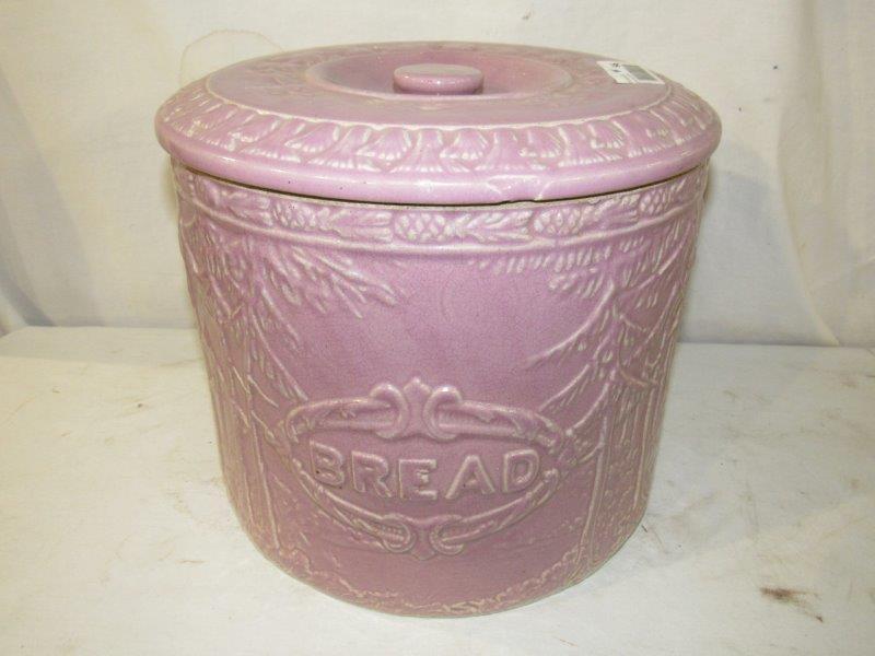 Large lavender pottery dough jar with lid: Does have a 4-inch crack from the top down and a few small age cracks when you look inside of crock on bottom but can't see from the outside. 11 1/2 in diameter 9 1/2 inches tall.
