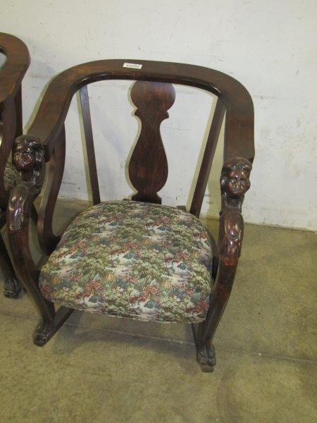 Rocker with carved Minerva head arms & claw feet: Has some damage on Minerva head armrests both have small chips. Floral padded seat.