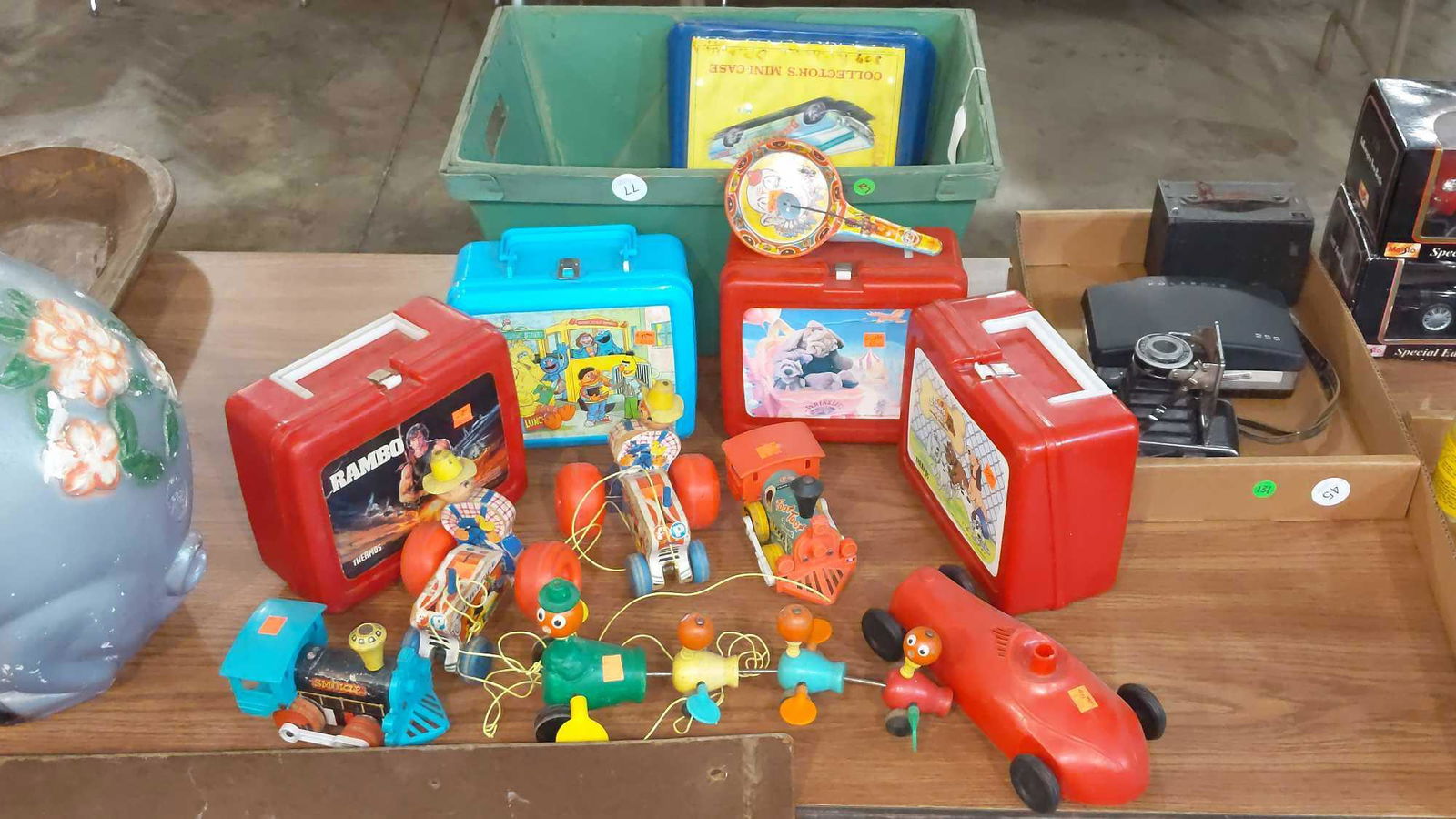 Vintage lunch box and toy lot: Includes 4- lunch boxes and numerous Fisher Price toys. Three of the lunch boxes have thermoses.