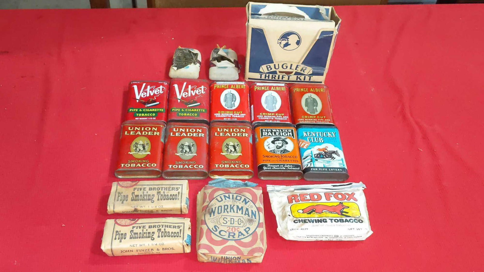 Box lot of vintage tobacco tins: 10 tobacco tins includes Kentucky Club, Velvet, Prince Albert, Sir Walter Raleigh and Union leader. Also includes vintage unopened chewing and smoking tobacco packs.