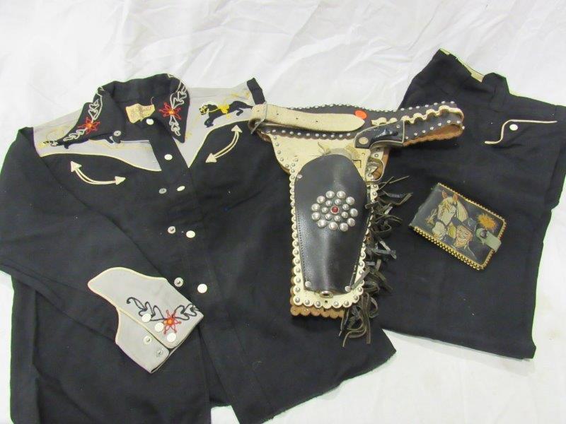 Incredible Western lot: Includes a fancy dual cap gun holster with single cap gun Marked cowboy. Leather holster with studded borders. Also includes J Bar T Western Wear child's size 12 suit, ( pants & shirt). Also includes