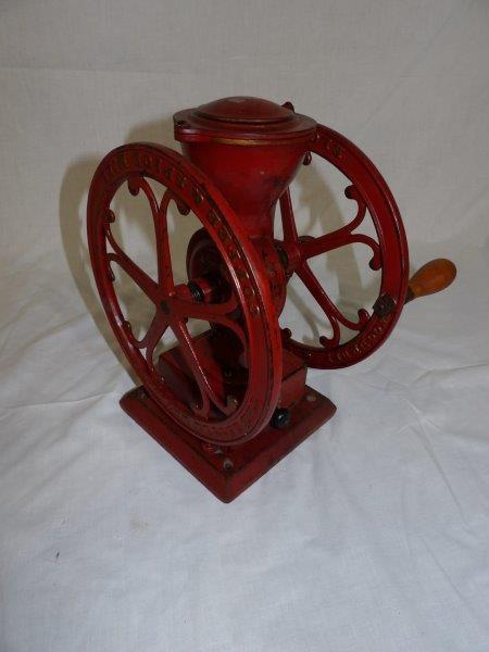 The Little National Woodruff & Edwards Co. coffee meal: This is an excellent two-wheel coffee mill, appears to be original paint. Shows minor wear, but Overall in good condition!! 614 in wide 12 1/2 in tall.