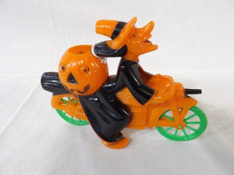 Rosbro Halloween Witch on bike with pumpkin candy: This is made of hard plastic and is in very good condition! Approximately 7 in Long and 5 in tall.