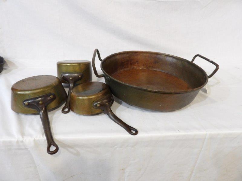 Four-piece copper cookware: Includes a two-handled copper pan 16 in in diameter and three smaller pots with handles that range from 5 and 1/2 in in diameter to 7 in.