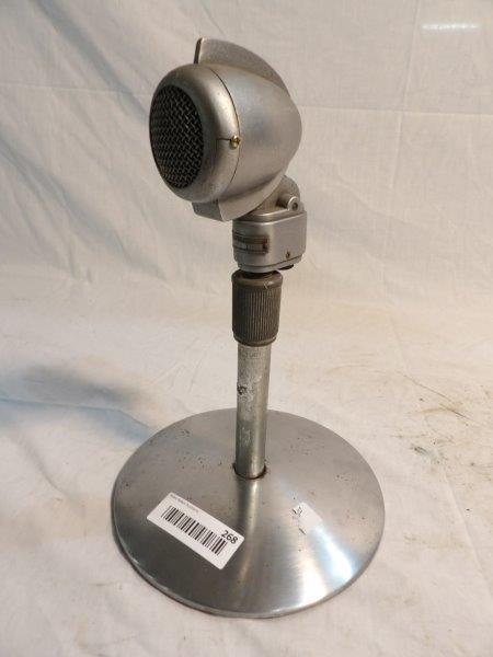 Vintage 1950s Turner 22D microphone: Mounted on stand, is not wired. Face of microphone has a t-shaped crack. Base of stand is eight inches in diameter, overall height is approximately 12 in.