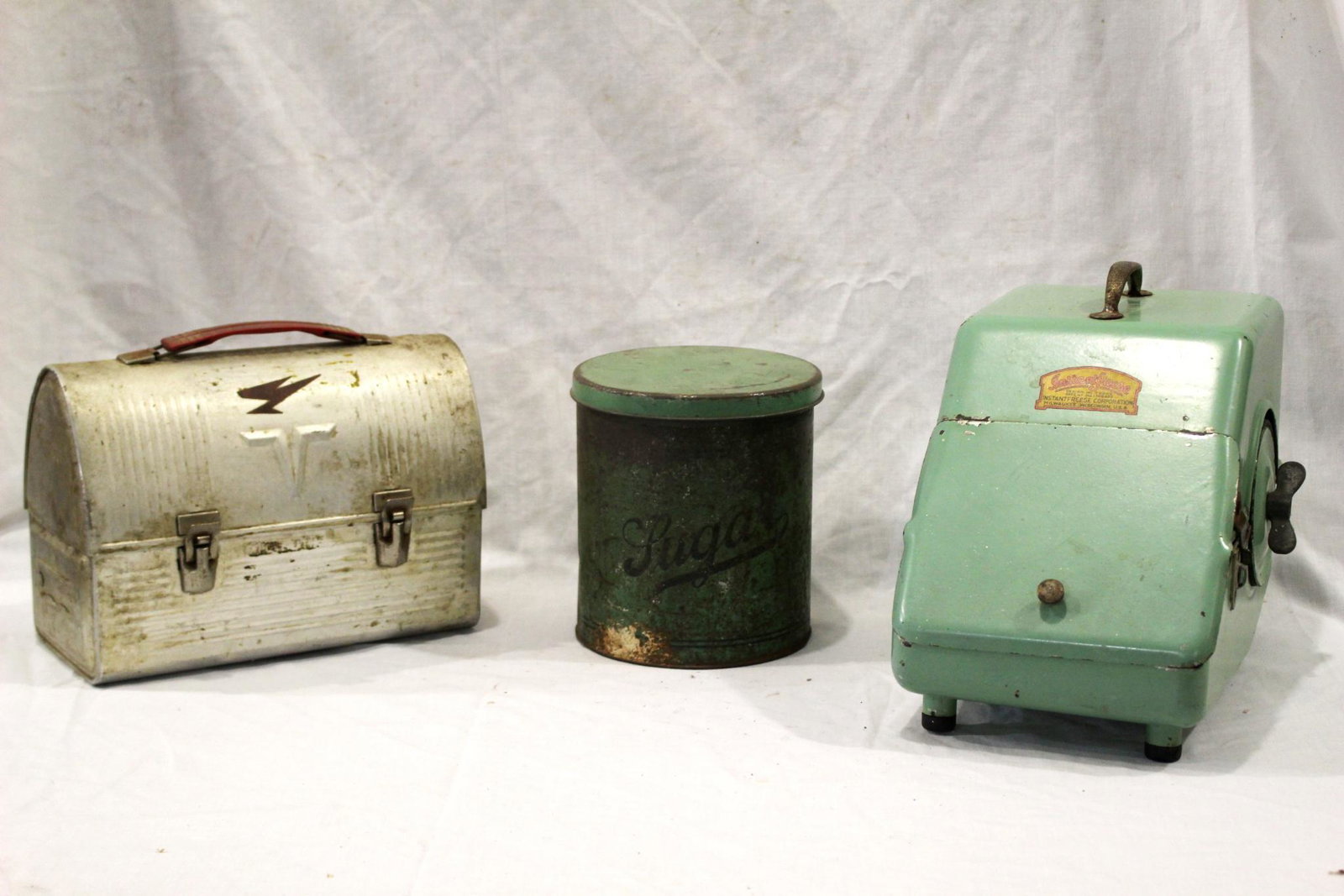 Vintage Tin & Metal Collection Group: Includes tin lunch pal, Instant Freese Jaddite green metal kitchen container (front lid glued shut) and a tin lidded Sugar canister. All with wear as shown, see photos. Instant freese measuring approx